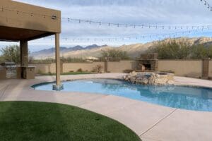 Backyard pool with mountain view and patio.