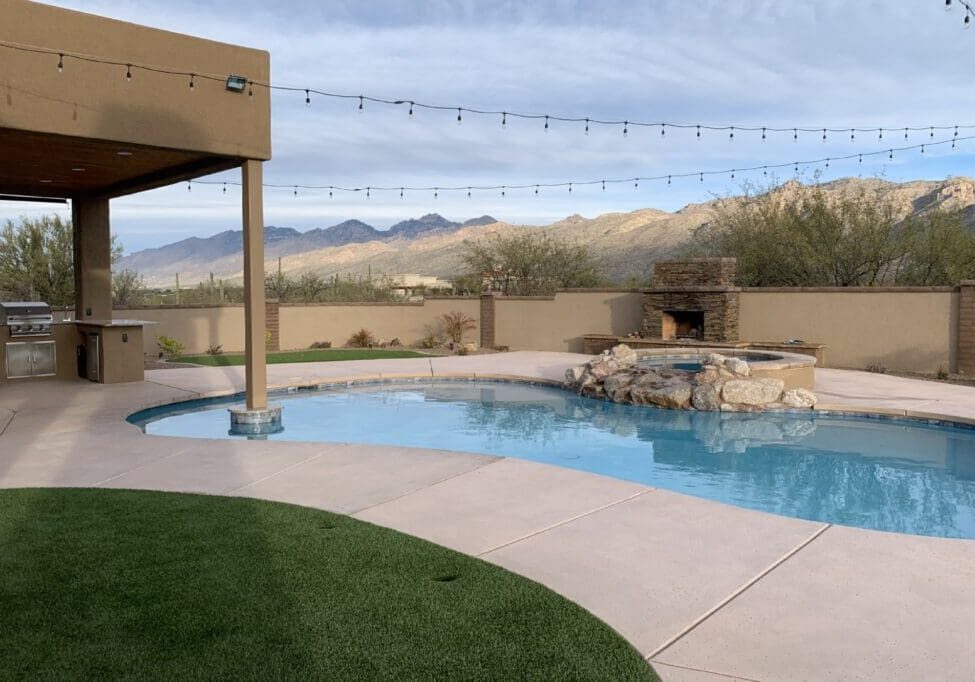 Backyard pool with mountain view and patio.
